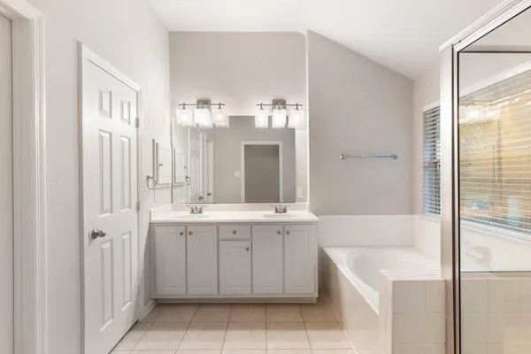 a bathroom with a bathtub and a sink