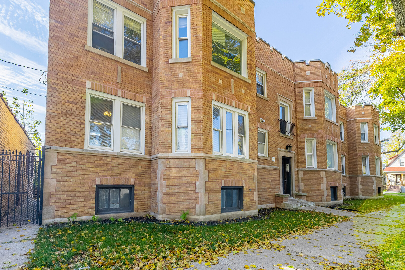 2453 West 56th Street, Unit R1 Chicago, IL 60629 - Photo 1 of 14 a brick building next to a yard