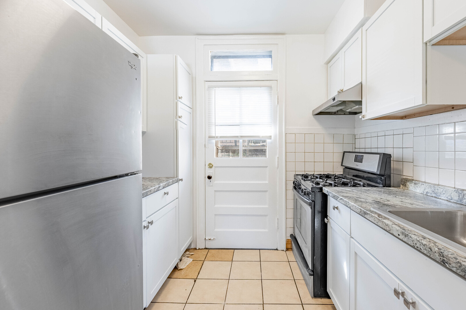 2453 West 56th Street, Unit R1 Chicago, IL 60629 - Photo 13 of 14 a kitchen with a stove a refrigerator and a sink