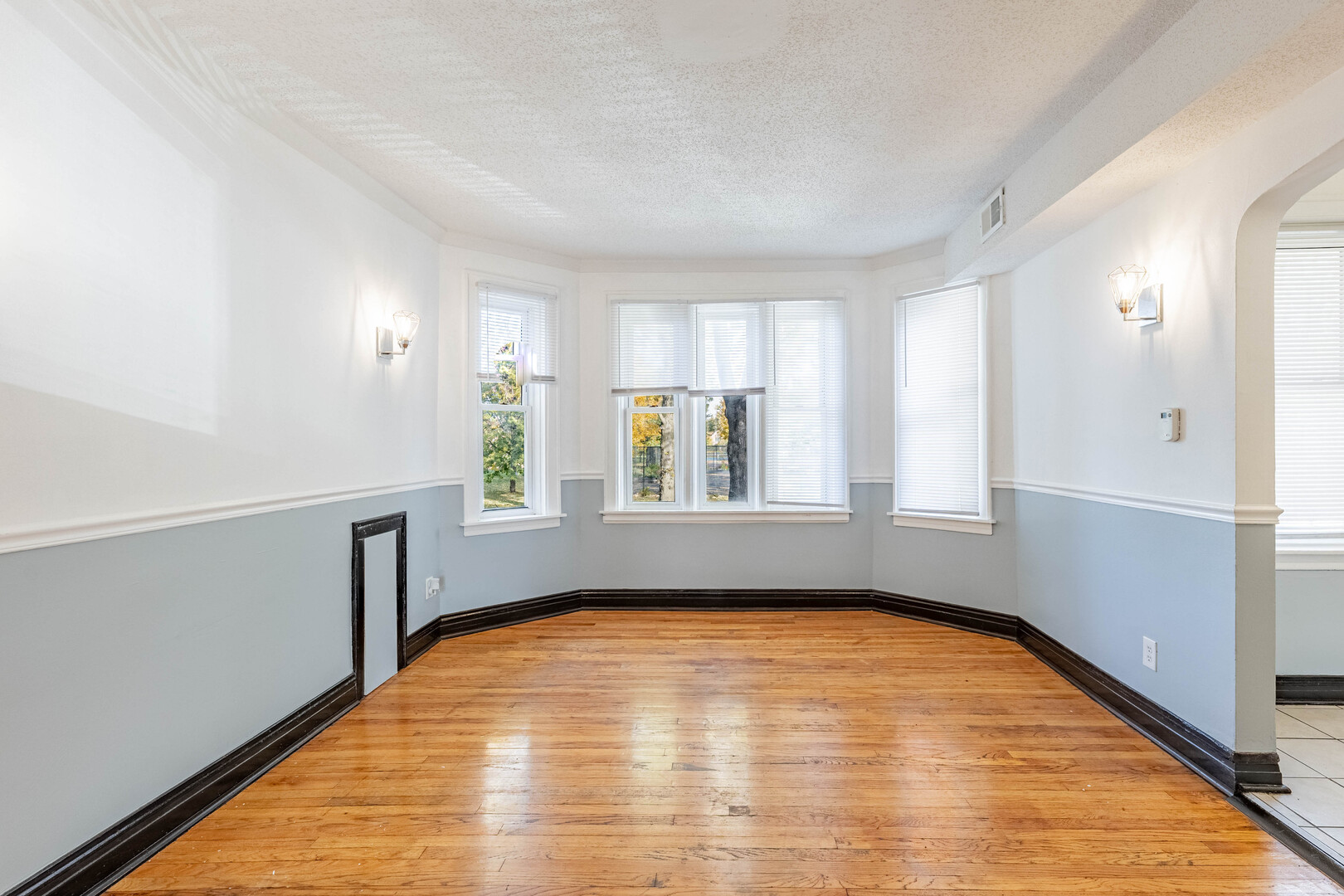 2453 West 56th Street, Unit R1 Chicago, IL 60629 - Photo 3 of 14 a view of empty room with wooden floor and fan