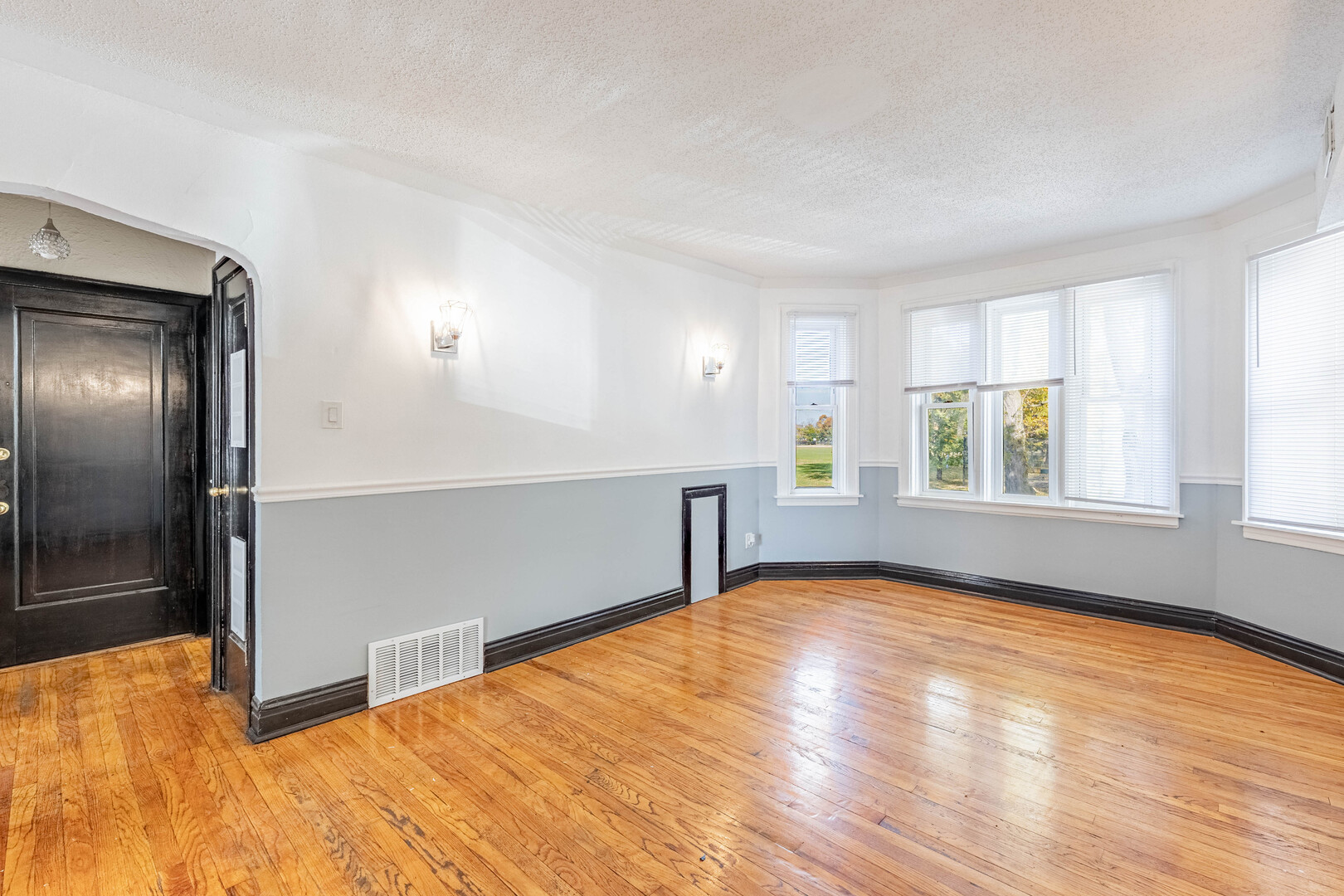 2453 West 56th Street, Unit R1 Chicago, IL 60629 - Photo 4 of 14 a view of an empty room with window and wooden floor