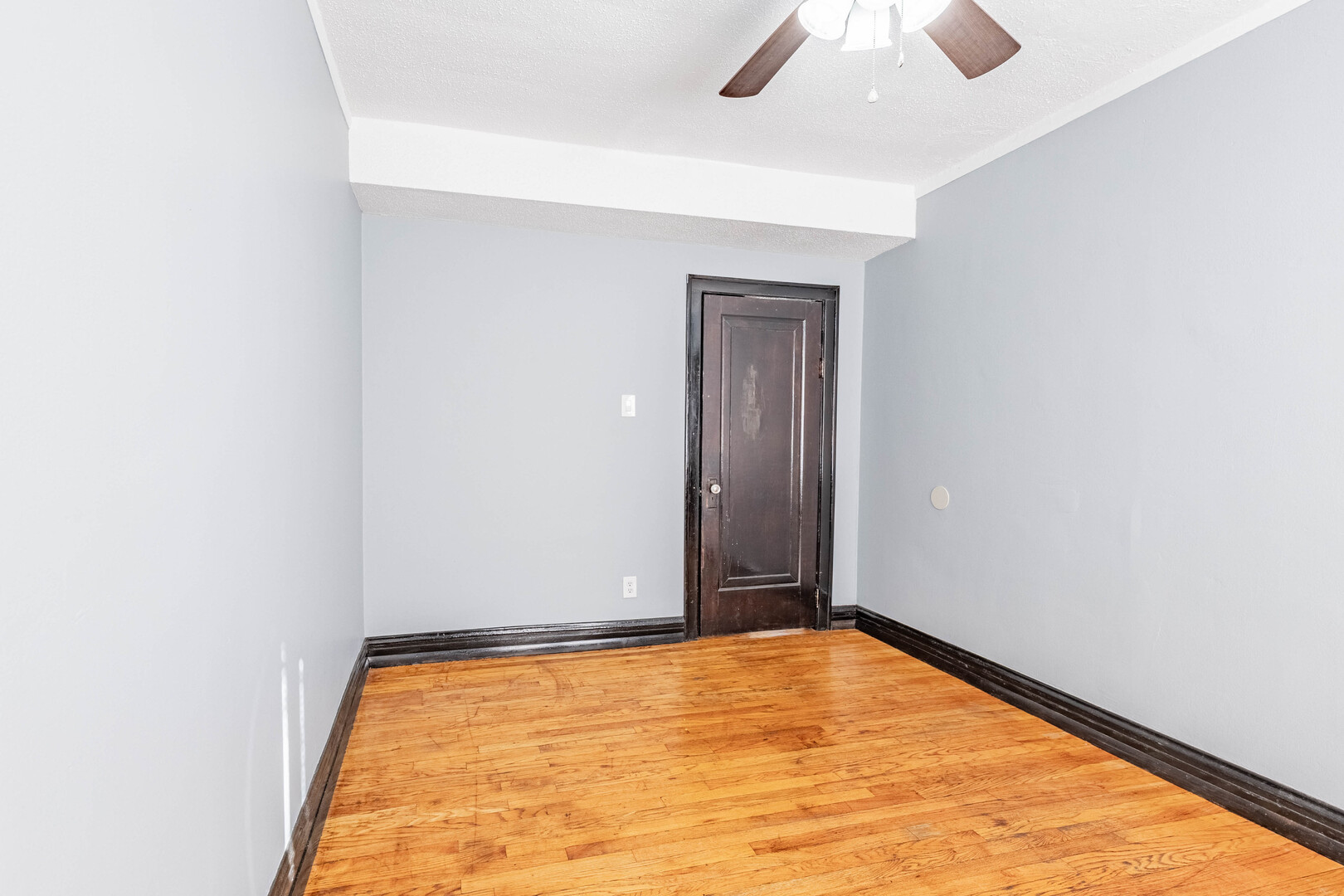 2453 West 56th Street, Unit R1 Chicago, IL 60629 - Photo 6 of 14 an empty room with ceiling fan and window