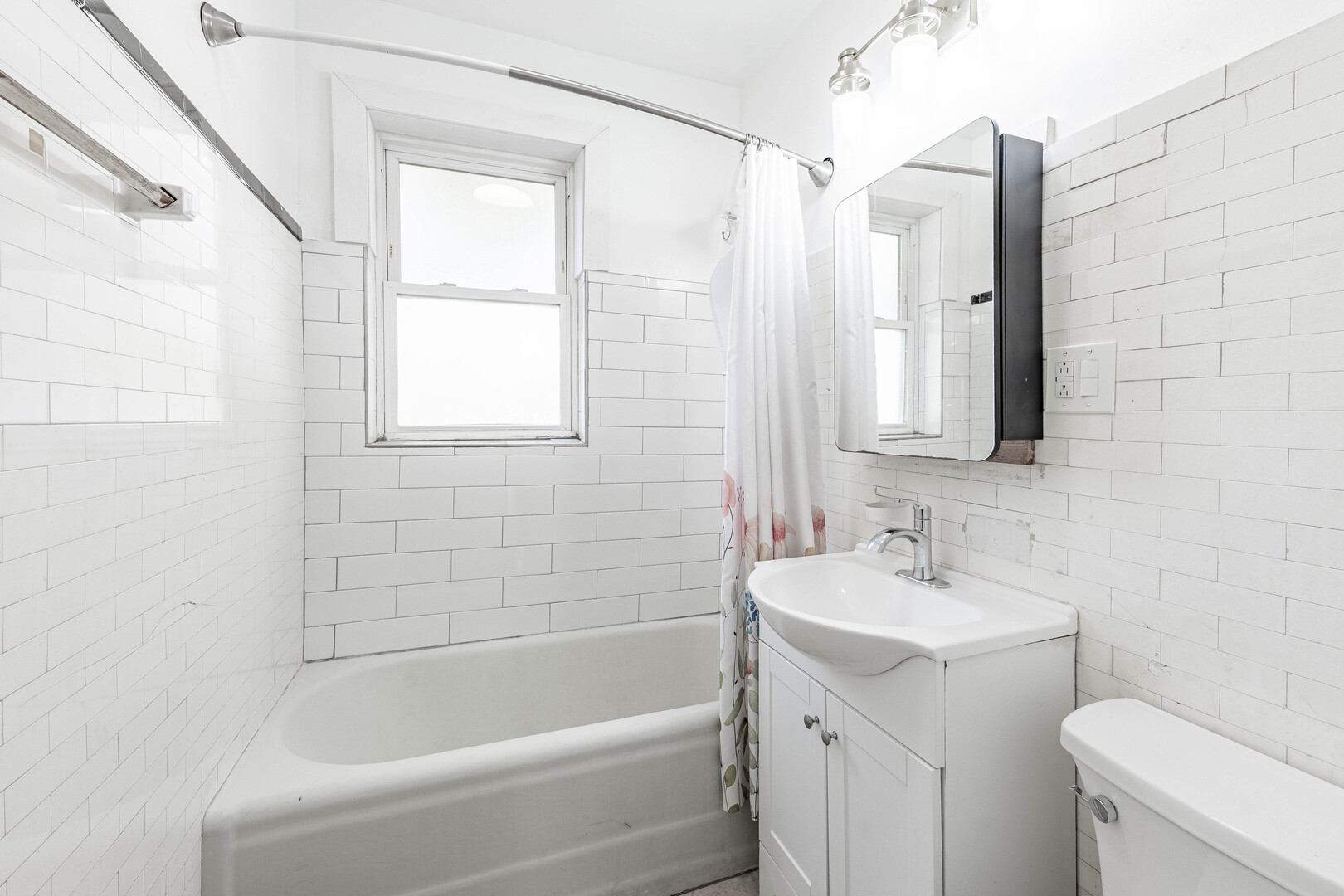 2453 West 56th Street, Unit R1 Chicago, IL 60629 - Photo 10 of 14 a white bath tub sitting next to a white sink and a toilet