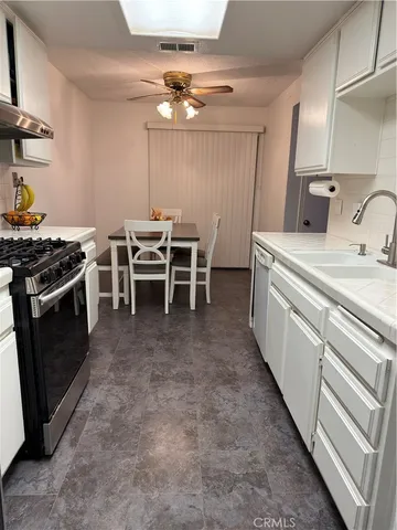 a kitchen with a stove and a sink