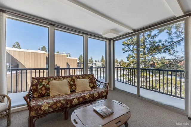 a living room with furniture and a floor to ceiling window