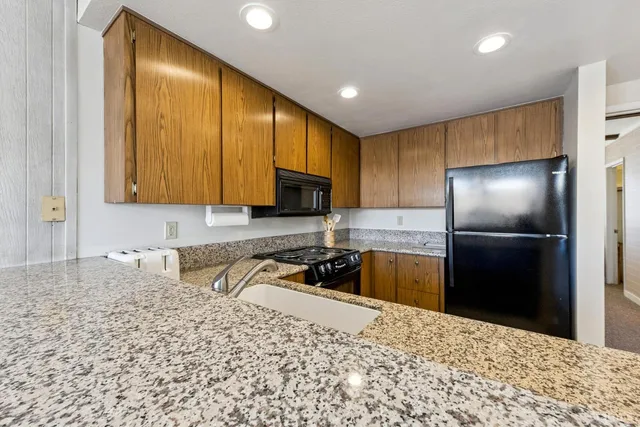 a kitchen with a refrigerator sink and microwave