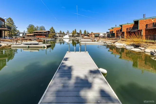 a view of a lake with boats and trees in the background