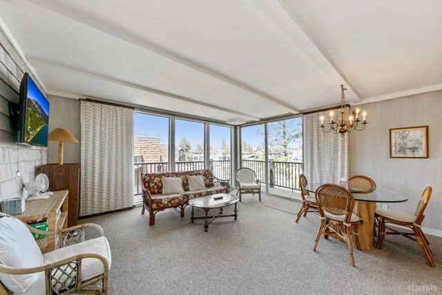 a living room with furniture and a floor to ceiling window