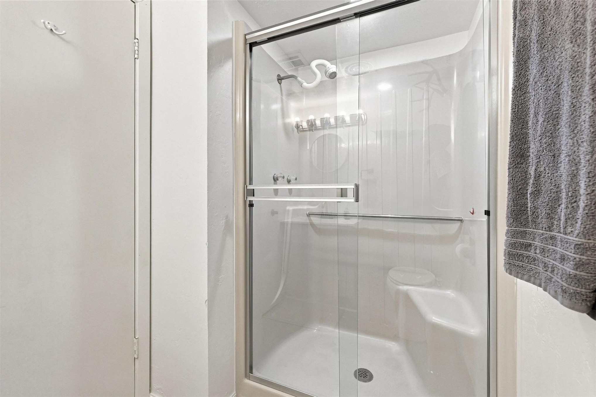 171 Woods Road Mead, OK 73449 - Photo 40 of 62 Enclosed shower with clear glass door, integrated seating, and grab bars