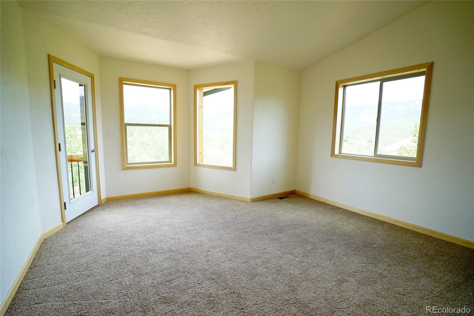 311 Quartz Circle Bailey, CO 80421 - Photo 17 of 30 an empty room with windows