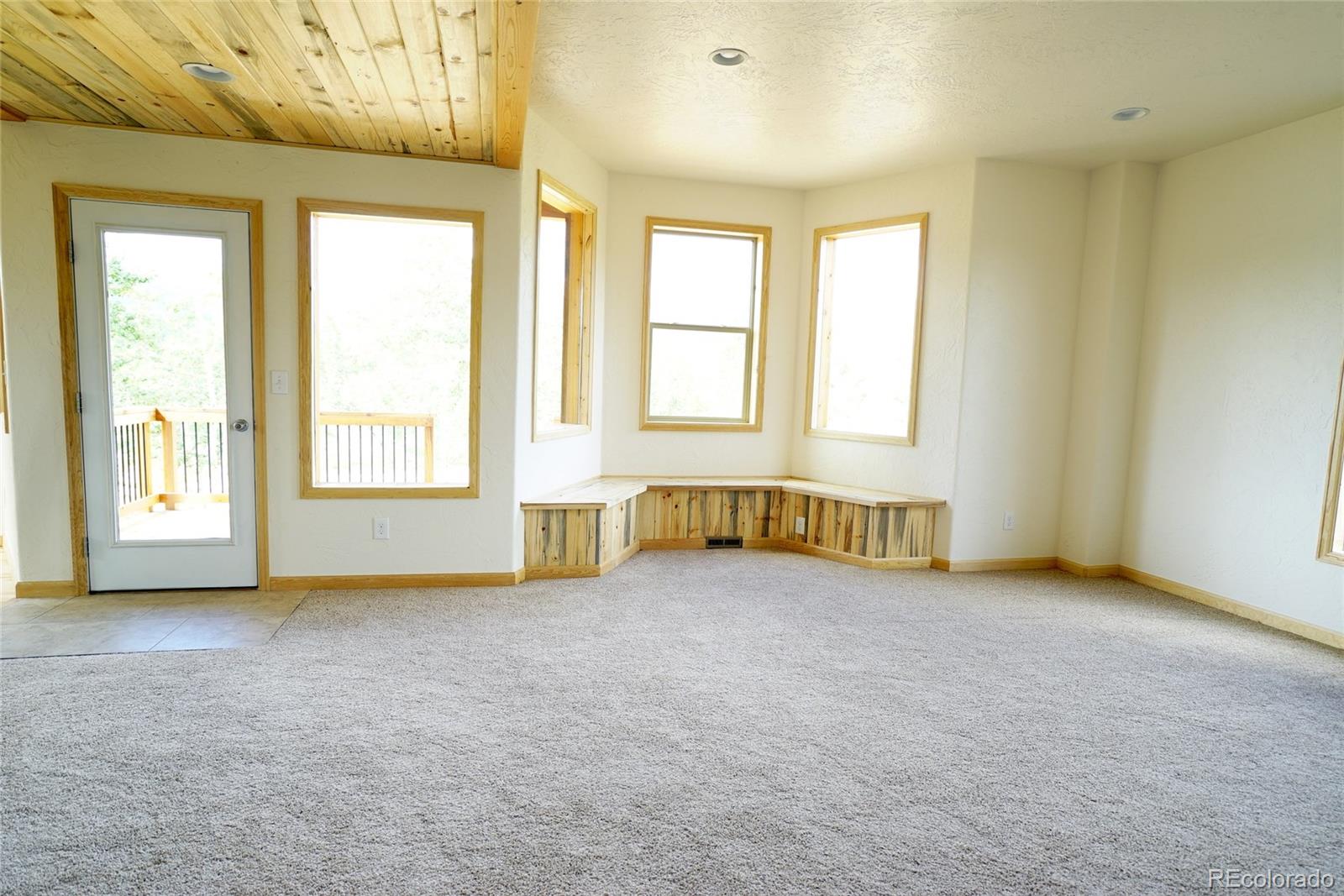 311 Quartz Circle Bailey, CO 80421 - Photo 19 of 30 an empty room with windows
