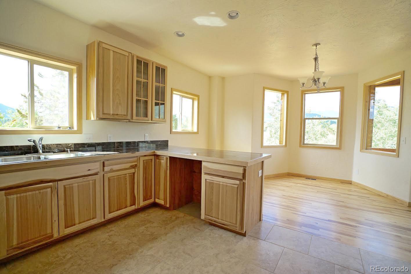 311 Quartz Circle Bailey, CO 80421 - Photo 7 of 30 a spacious bathroom with a granite countertop sink and a window