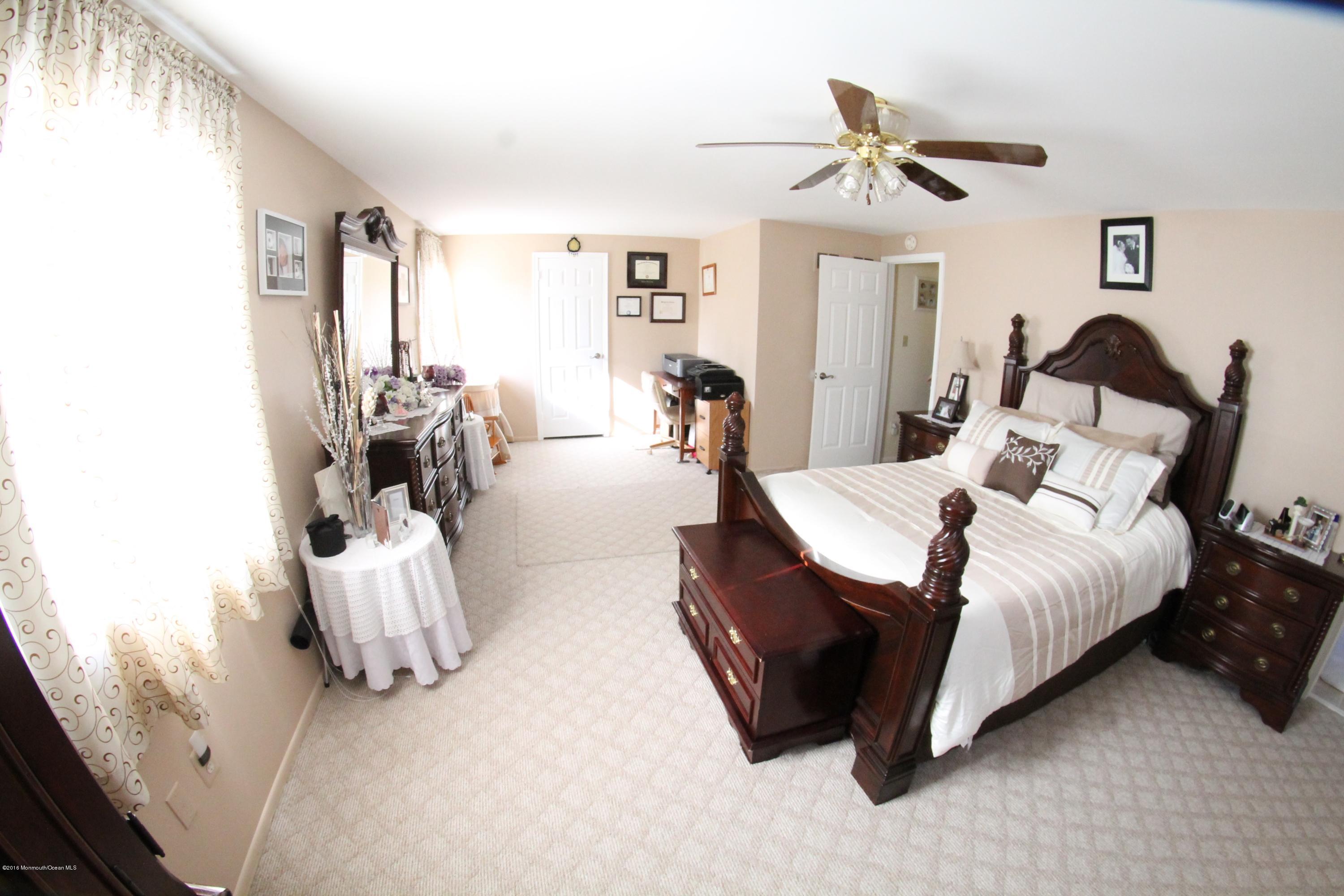 13 Partree Road Jackson, NJ 08527 - Photo 13 of 17 a bed room with a bed and a couch