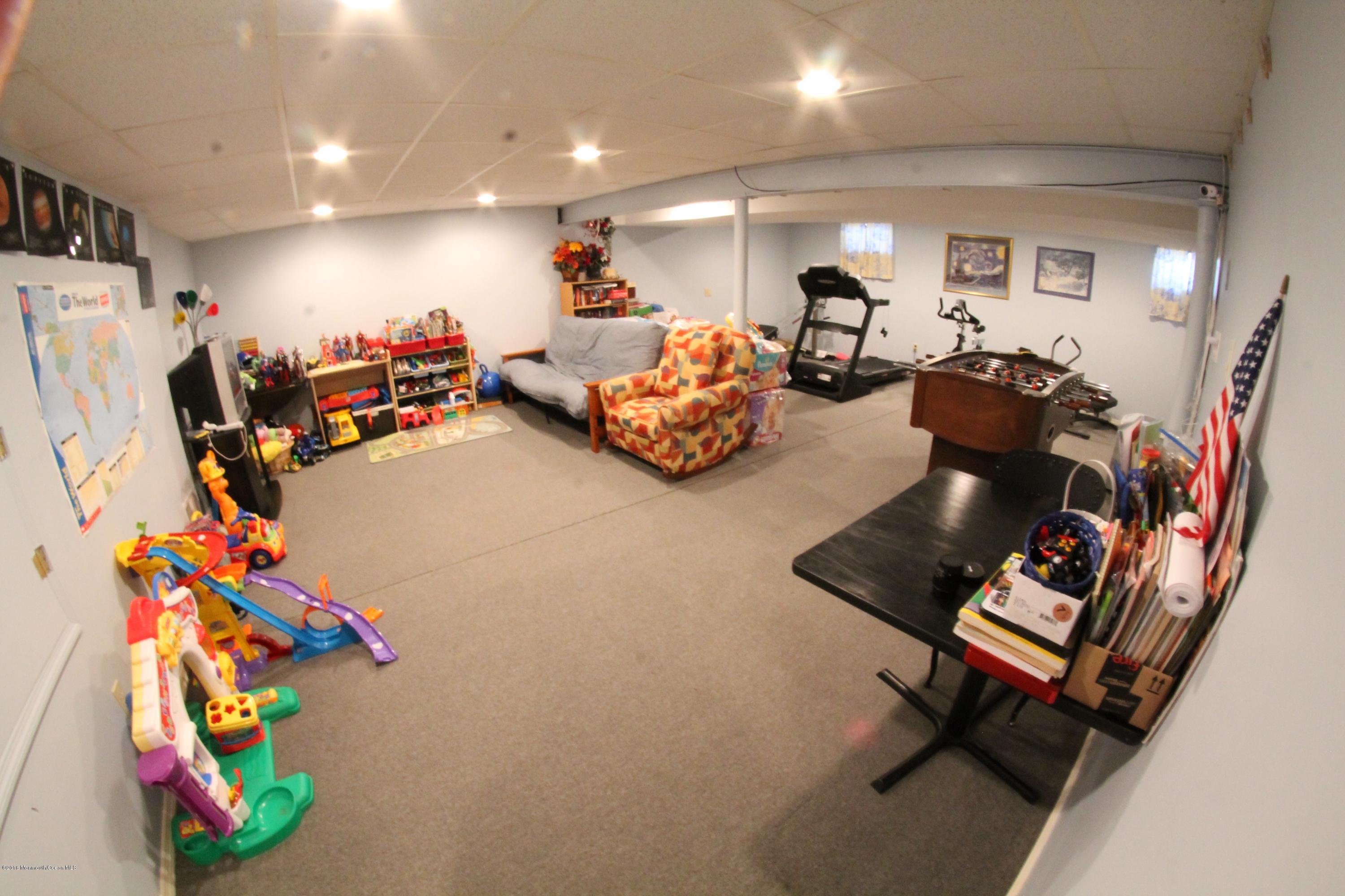13 Partree Road Jackson, NJ 08527 - Photo 15 of 17 a room with gym equipment and a flat screen tv