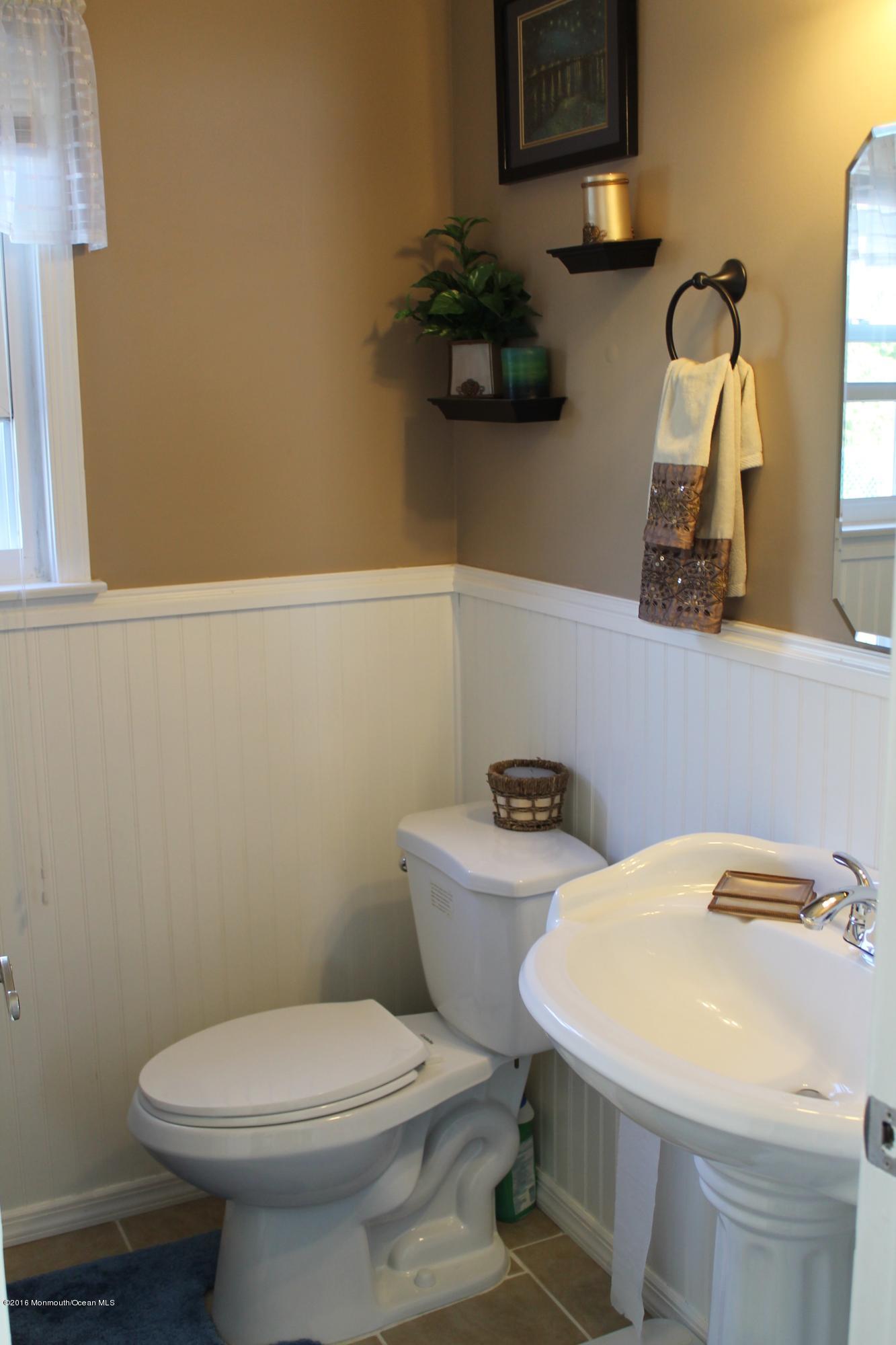 13 Partree Road Jackson, NJ 08527 - Photo 3 of 17 a bathroom with a sink a toilet and a mirror