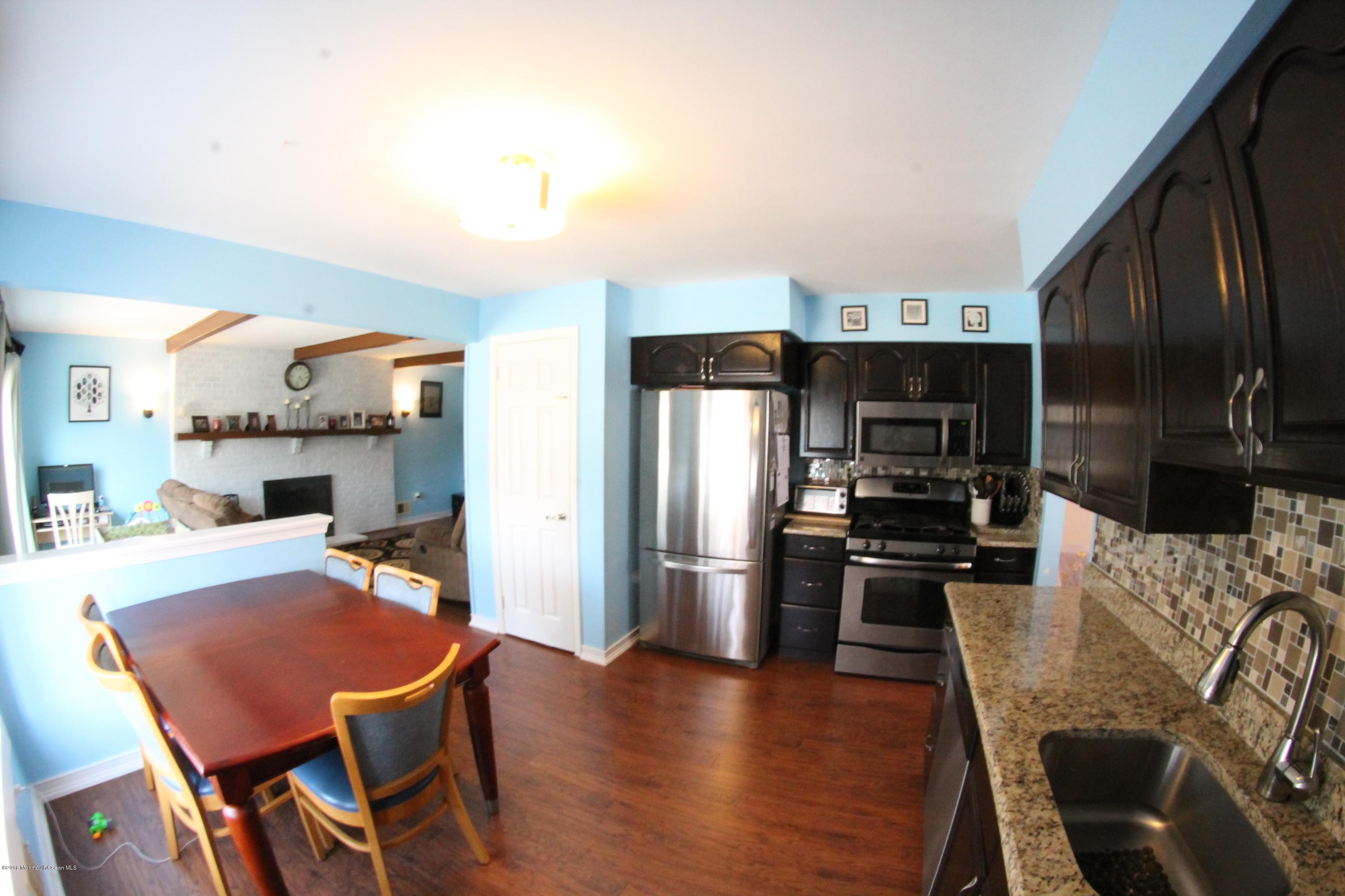 13 Partree Road Jackson, NJ 08527 - Photo 6 of 17 a kitchen with a dining table chairs and refrigerator