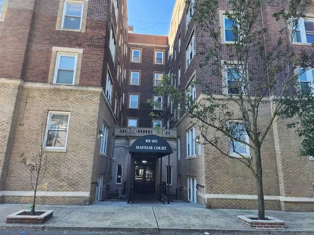 a front view of a building with a fountain