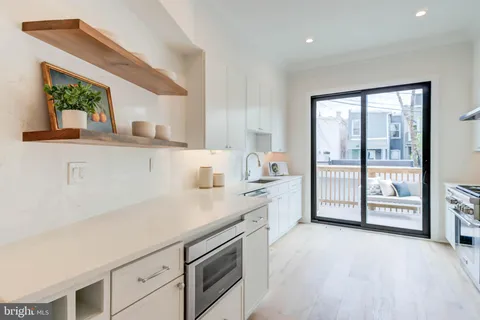 a view of a kitchen with a sink and a window