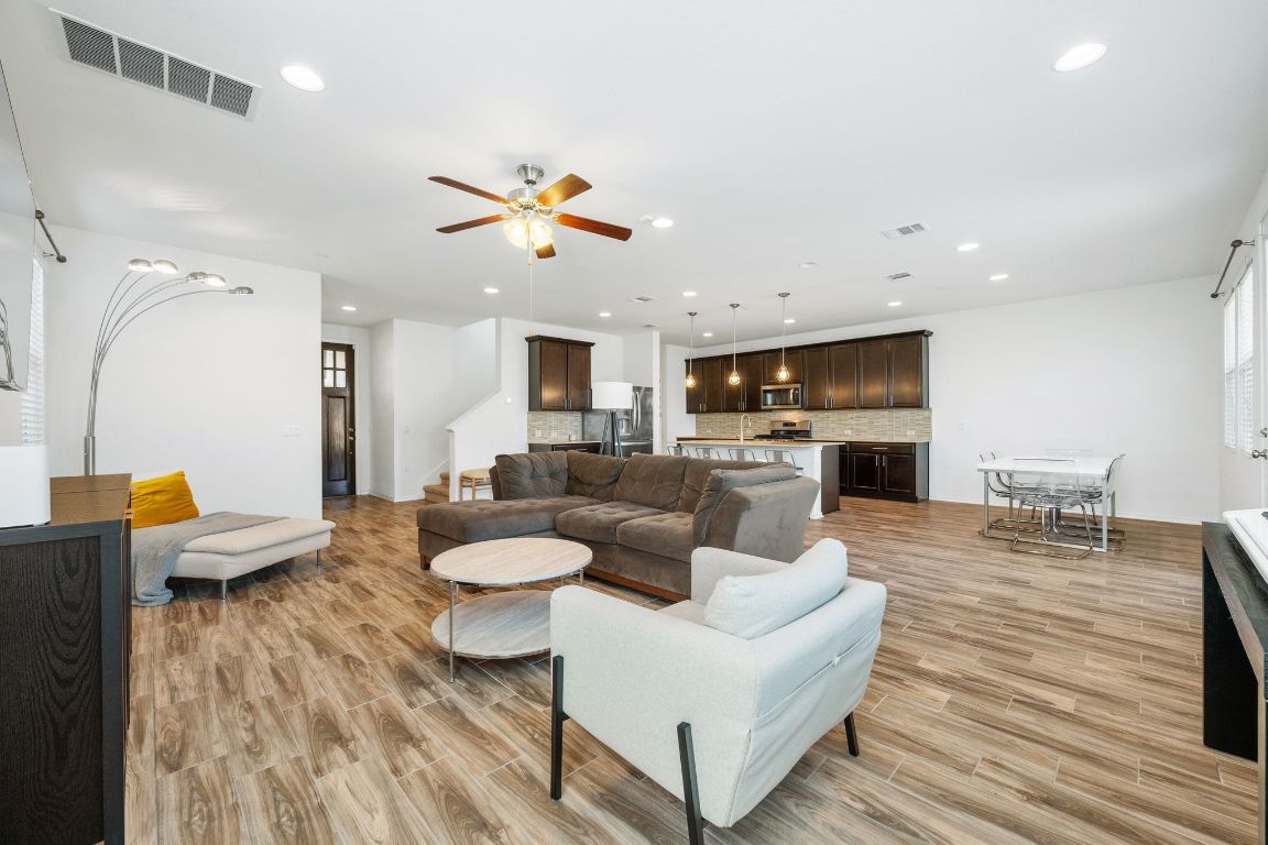 1902 Tasmanian Tiger Trace Austin, TX 78728 - Photo 1 of 29 a living room with fireplace furniture and a wooden floor