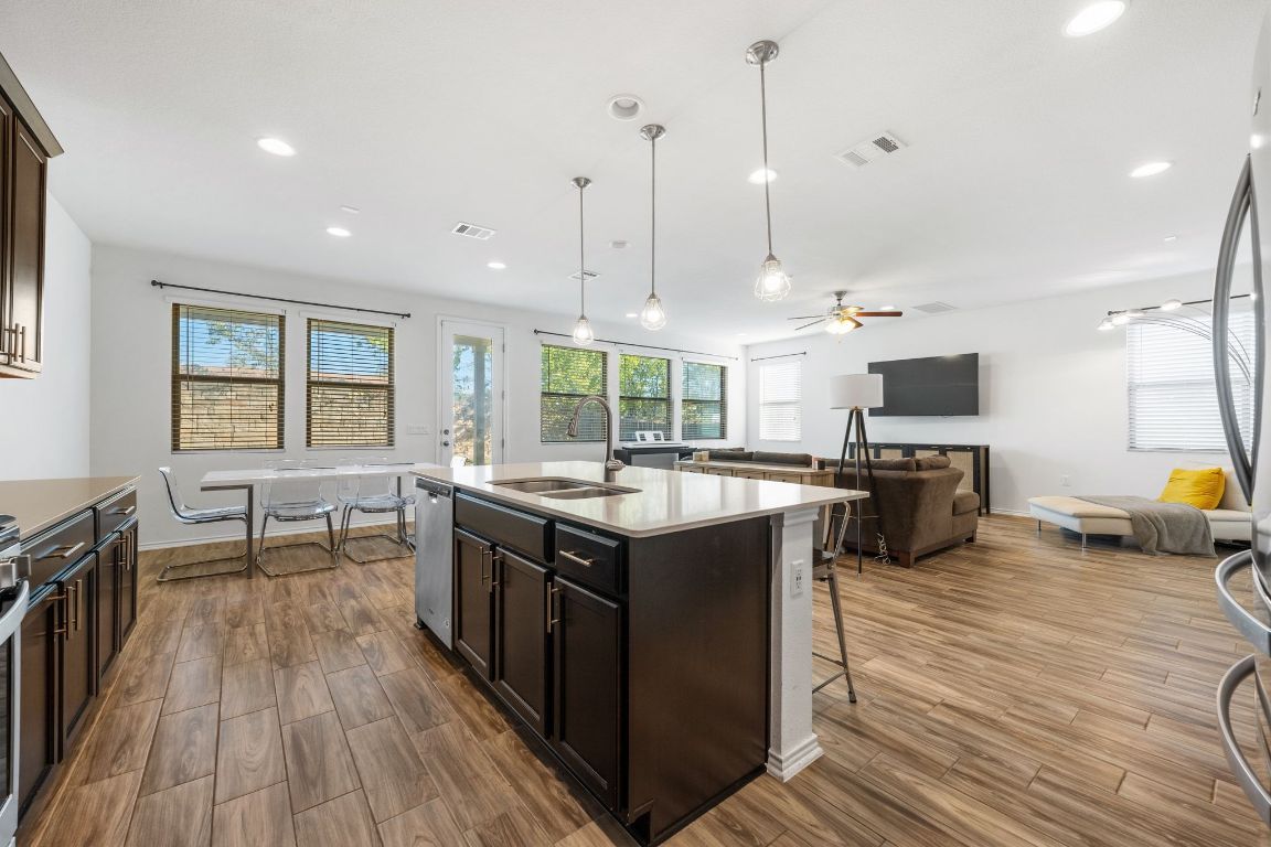 1902 Tasmanian Tiger Trace Austin, TX 78728 - Photo 27 of 29 a kitchen with stainless steel appliances granite countertop a stove and a wooden floors