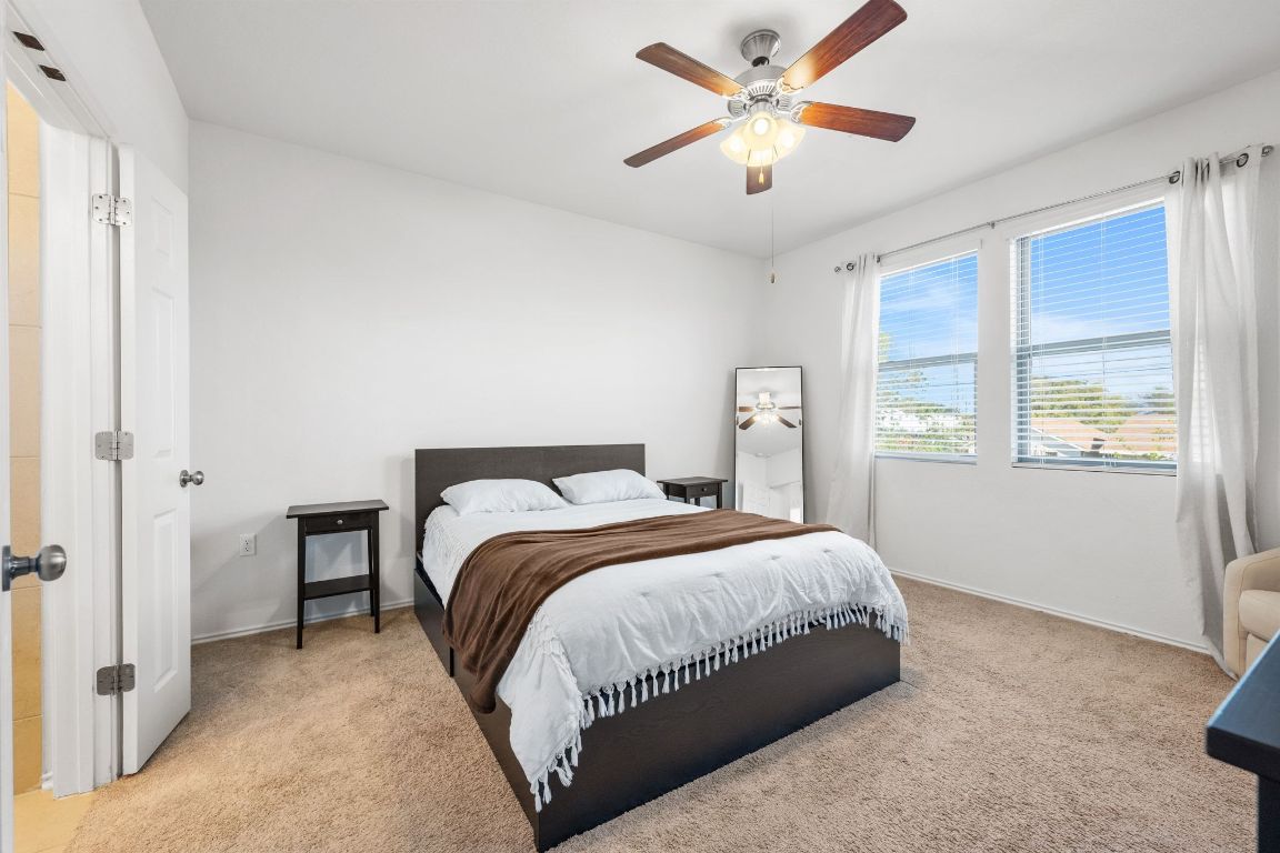 1902 Tasmanian Tiger Trace Austin, TX 78728 - Photo 13 of 29 a bedroom with a large bed and a window