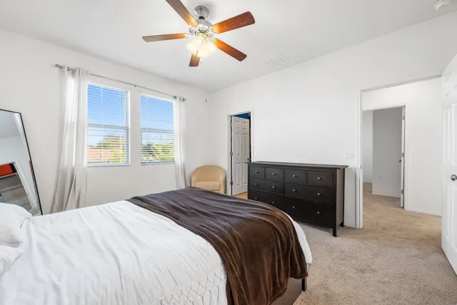 a large kitchen with stainless steel appliances a stove a sink and a refrigerator