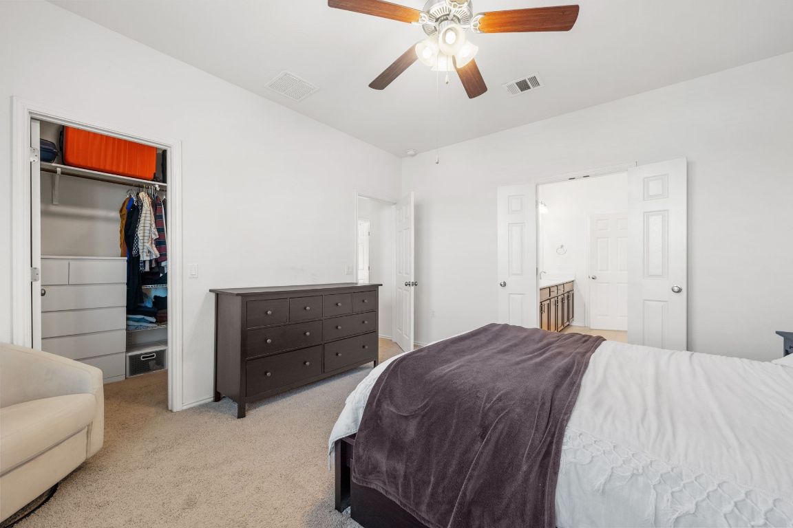 1902 Tasmanian Tiger Trace Austin, TX 78728 - Photo 15 of 29 a bedroom with a bed and a dresser