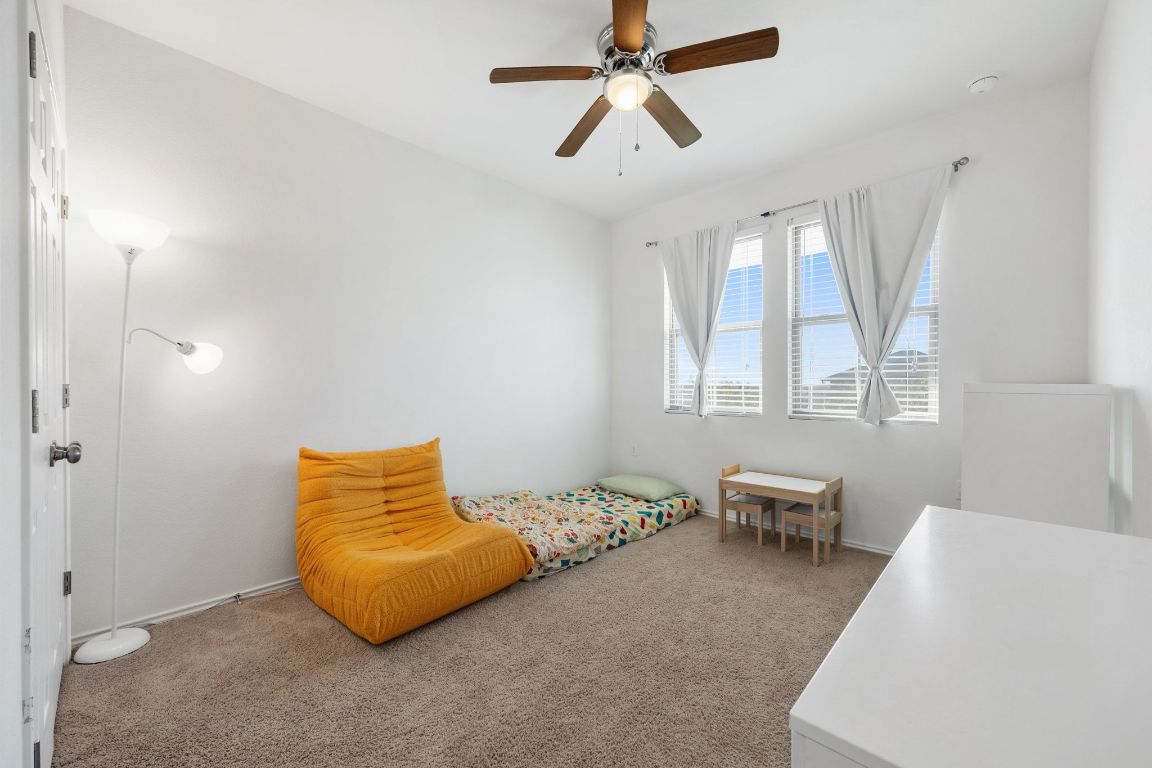 1902 Tasmanian Tiger Trace Austin, TX 78728 - Photo 17 of 29 a bedroom with a bed and chair