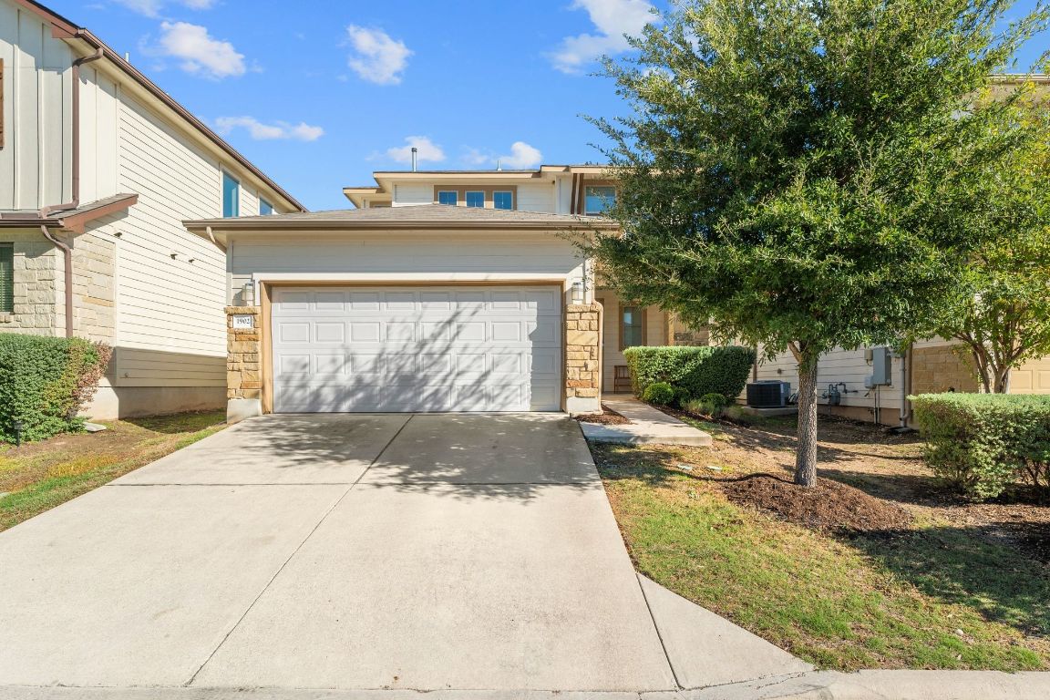 1902 Tasmanian Tiger Trace Austin, TX 78728 - Photo 2 of 29 a front view of a house with a yard and garage