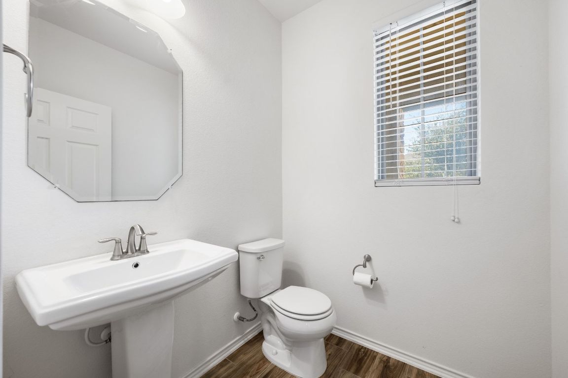 1902 Tasmanian Tiger Trace Austin, TX 78728 - Photo 20 of 29 a bathroom with a sink a toilet and mirror