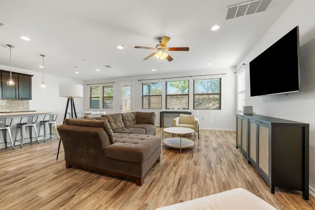 a living room with fireplace furniture and a flat screen tv