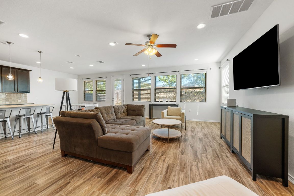 1902 Tasmanian Tiger Trace Austin, TX 78728 - Photo 4 of 29 a living room with fireplace furniture and a flat screen tv