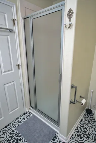 a bathroom with double vanity and a mirror