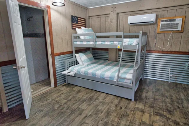 a view of a hallway with wooden floor and windows