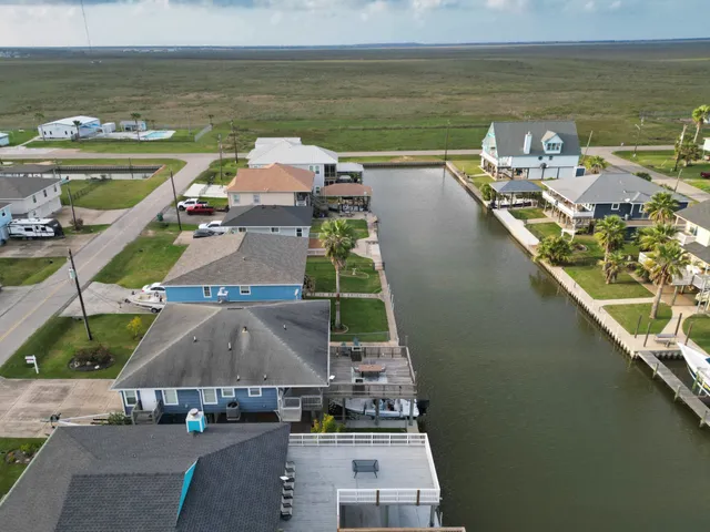 an aerial view of residential houses with outdoor space and swimming pool