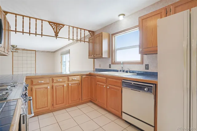a view of a kitchen with a stove cabinets and a floor to ceiling window