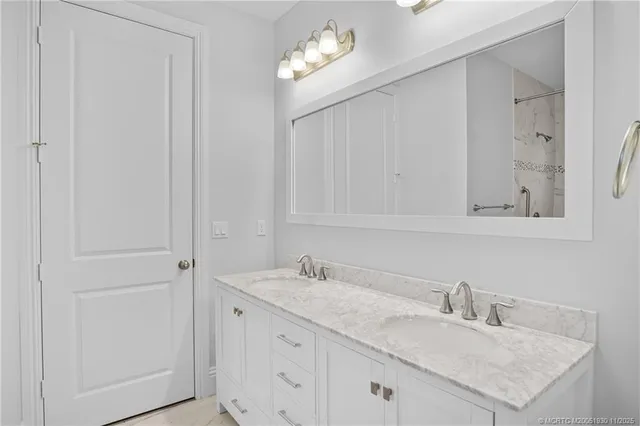 a bathroom with a sink vanity and mirror