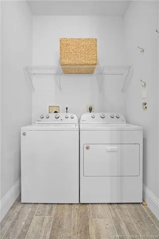 a dining room with furniture and large windows