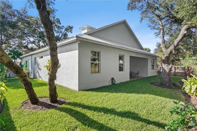 a view of a house with backyard porch and sitting area