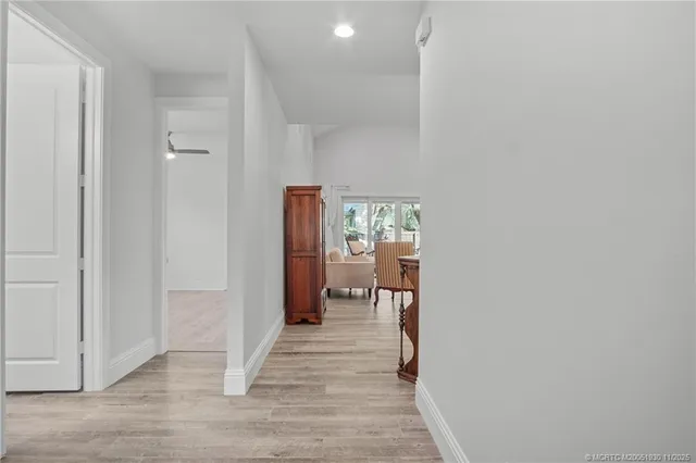 a view of a hallway with wooden floor
