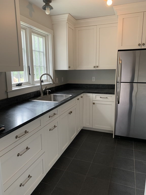 1481 Bay Road Sharon, MA 02067 - Photo 12 of 29 a kitchen with granite countertop white cabinets and white appliances