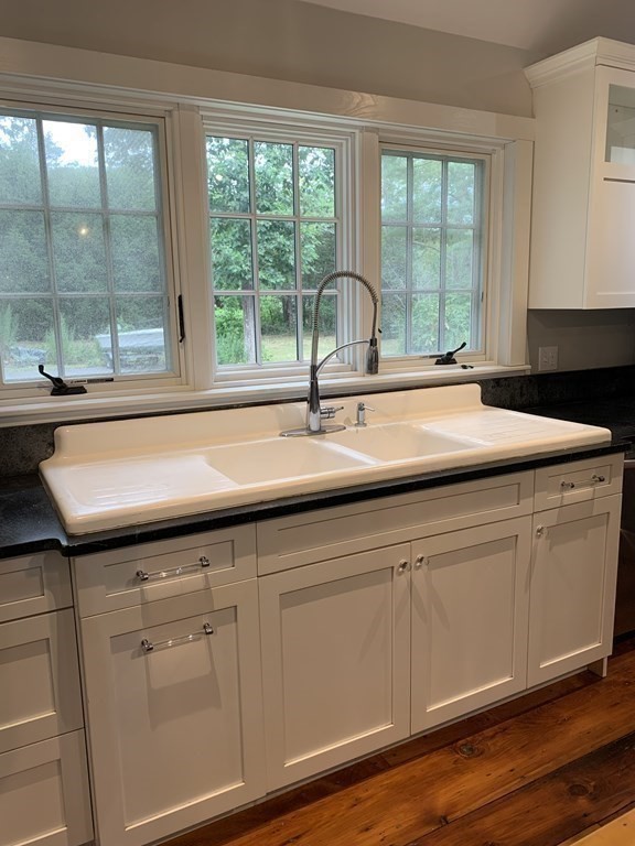 1481 Bay Road Sharon, MA 02067 - Photo 16 of 29 a sink with white cabinets and a large window