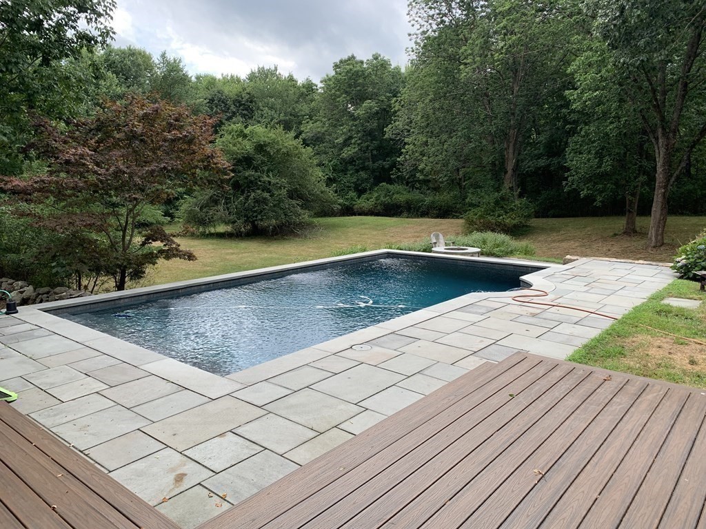1481 Bay Road Sharon, MA 02067 - Photo 10 of 29 a view of a swimming pool on a patio