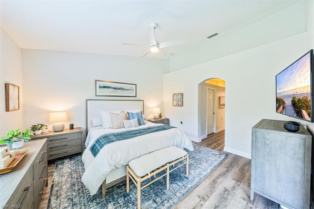 20280 Burnside Place, Unit 1202 Estero, FL 33928 - Photo 23 of 42 a bedroom with a bed and a flat screen tv