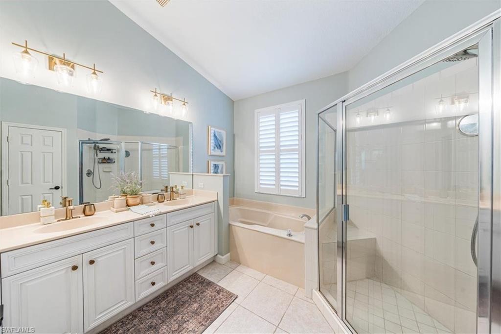 20280 Burnside Place, Unit 1202 Estero, FL 33928 - Photo 26 of 42 a spacious bathroom with a double vanity sink toilet mirror and bathtub