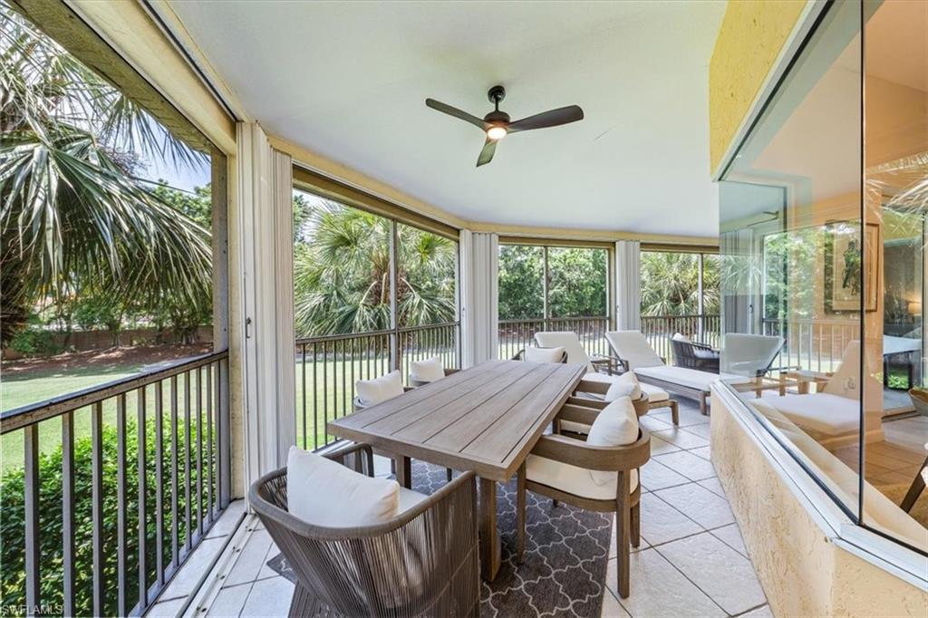 20280 Burnside Place, Unit 1202 Estero, FL 33928 - Photo 30 of 42 a living room with furniture and a floor to ceiling window
