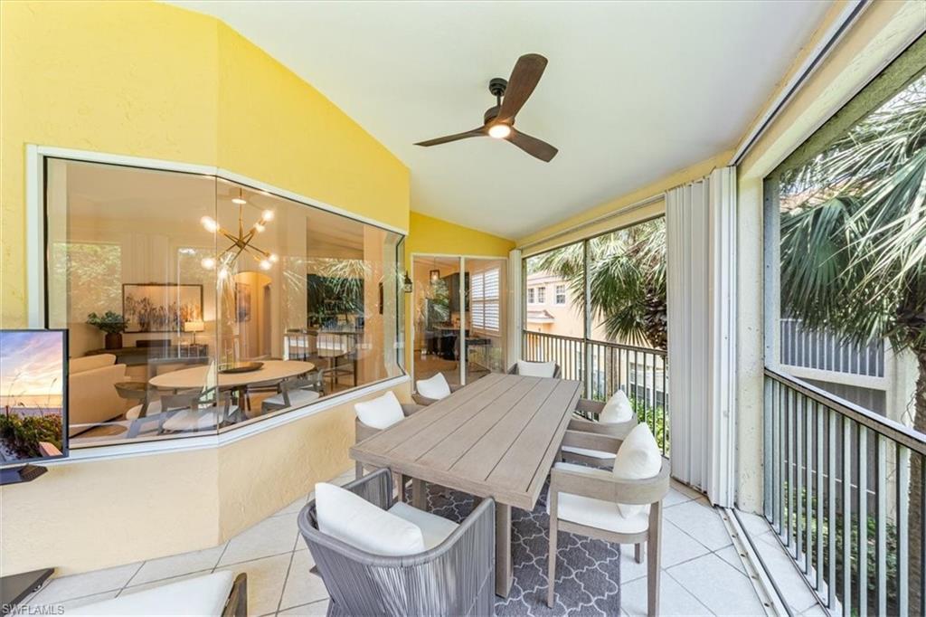 20280 Burnside Place, Unit 1202 Estero, FL 33928 - Photo 31 of 42 a dining room with furniture a chandelier and wooden floor