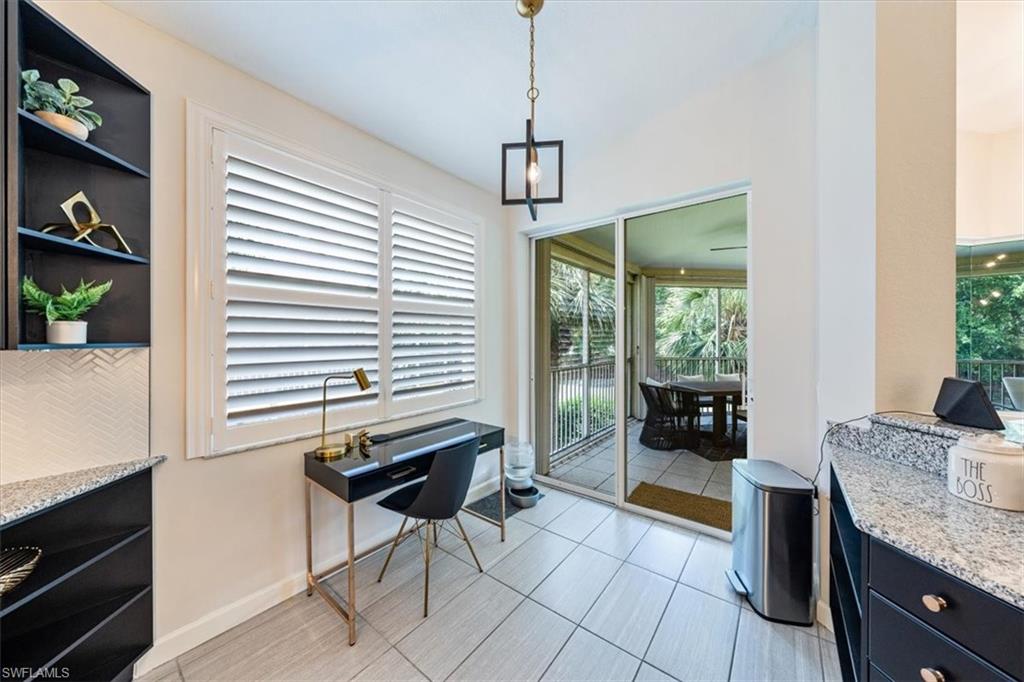 20280 Burnside Place, Unit 1202 Estero, FL 33928 - Photo 33 of 42 a dining room with furniture and a floor to ceiling window