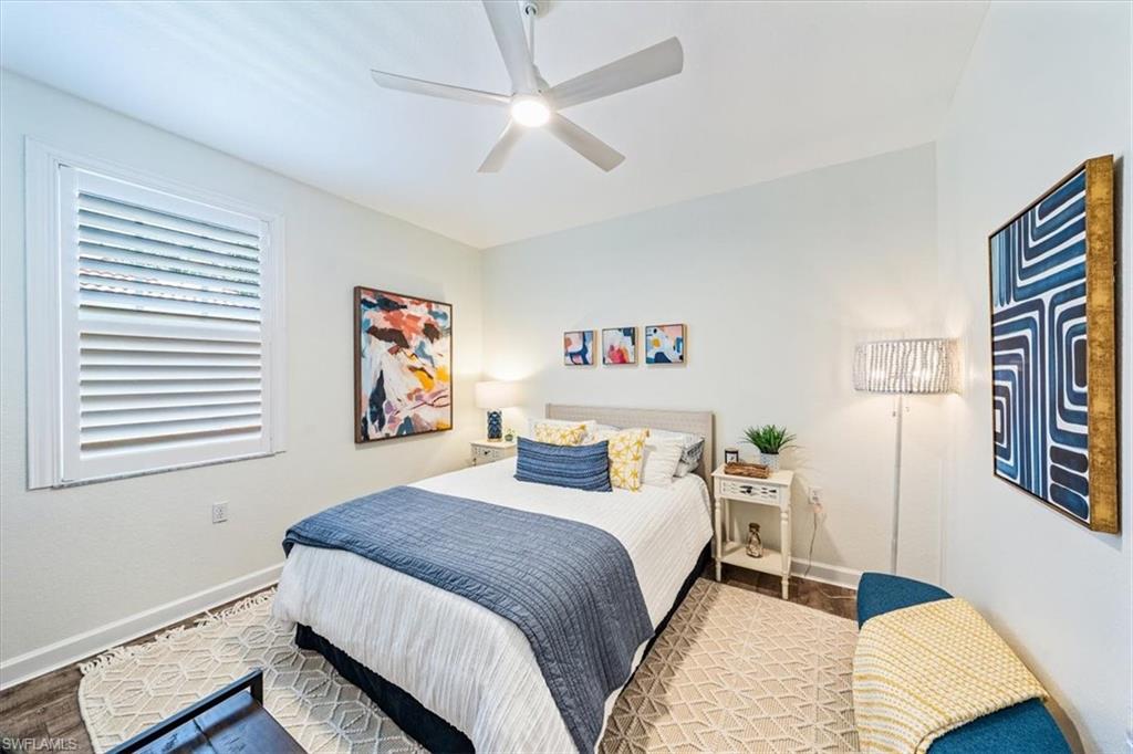 20280 Burnside Place, Unit 1202 Estero, FL 33928 - Photo 8 of 42 a bedroom with a bed and a painting on the wall