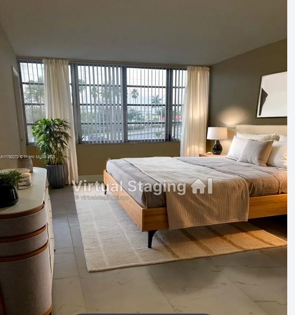 a bedroom with a bed and a large window